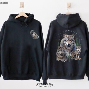 May include: Black hooded sweatshirt with a wolf howling at the moon graphic on the front and a group of wolves in a forest scene on the back.