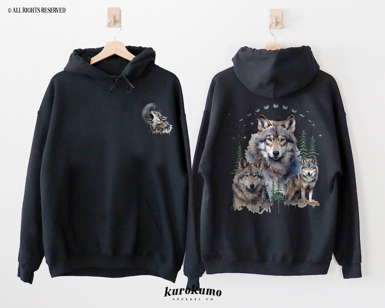 May include: Black hooded sweatshirt with a wolf howling at the moon graphic on the front and a group of wolves in a forest scene on the back.