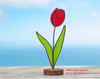 May include: A red stained glass tulip with green leaves on a wooden stand. Additional option: laser engraving on a stand.