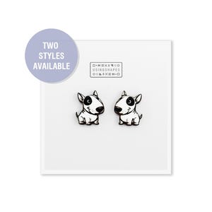 May include: Two white bull terrier dog earrings with black eyes and noses. The earrings are made using shapes. The text "TWO STYLES AVAILABLE" is on a purple circle and the text "D-N-X-X-O USING SHAPES O-I-X-X-M-O" is on a white rectangle.