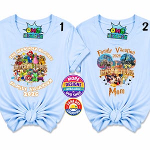 May include: Two light blue t-shirts with short sleeves and knotted hems. The first shirt features a graphic of Mario characters and the text "THE HERNANDEZ RAMIREZ FAMILY VACATION 2026". The second shirt displays a Mickey Mouse icon graphic and "FAMILY VACATION 2026 MOM".