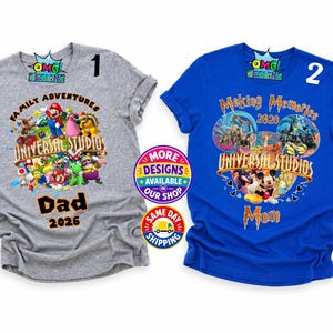 May include: A grey t-shirt with a graphic featuring Mario characters and the text Family Adventures Universal Studios Dad 2026, and a blue t-shirt with a graphic featuring Mickey Mouse and the text Making Memories 2026 Universal Studios Mom.