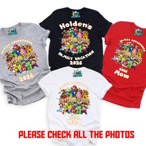 May include: Four short-sleeve t-shirts in gray, black, red, and white, each featuring a colorful graphic of Mario characters, the text "UNIVERSAL STUDIOS," "FAMILY ADVENTURES," and "2026," with specific labels like "Holden's," "Mom," and "Dad" on some shirts.