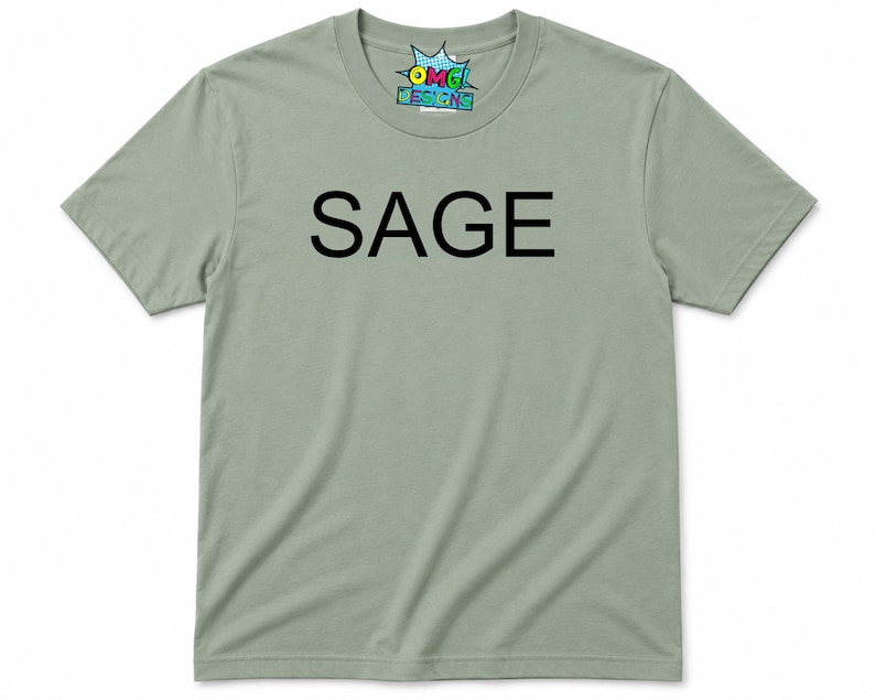 Puede incluir: Una camiseta de manga corta color verde salvia con la palabra SAGE impresa en letras may&uacute;sculas negras en el pecho. La etiqueta interior del cuello muestra el texto OMG DESIGNS en un gr&aacute;fico colorido de estilo c&oacute;mic con fondo de estrella.