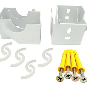 May include: White plastic brackets with four yellow plastic rawlplugs and screws. The brackets have a curved design and are used for mounting window blinds.