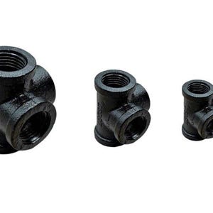 May include: Three black iron pipe fittings with multiple female threaded ends. The fittings are in different sizes.