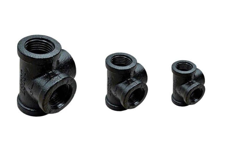 May include: Three black iron pipe fittings with multiple female threaded ends. The fittings are in different sizes.