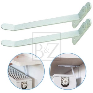 May include: Two white metal shelf brackets with a curved design. The brackets are shown mounted to a wall with a white shelf attached to them.