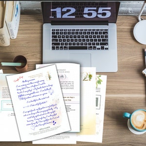 May include: A workspace scene featuring a laptop, books, and documents with handwritten text. A cup of coffee sits nearby. The laptop screen displays the time as 12:55. The documents have blue handwritten text.