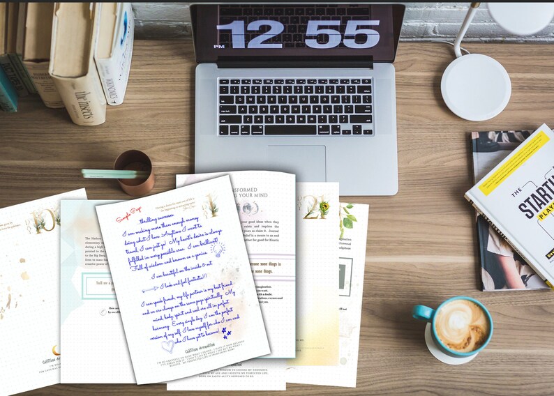 May include: A workspace scene featuring a laptop, books, and documents with handwritten text. A cup of coffee sits nearby. The laptop screen displays the time as 12:55. The documents have blue handwritten text.