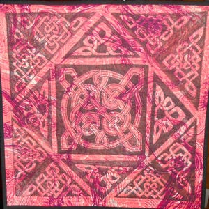 May include: A red and brown quilt with a Celtic knot design. The quilt is made of fabric with a marbled pattern.