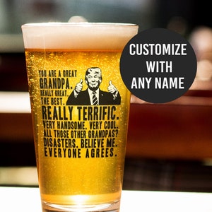 May include: A clear glass beer mug with a black and white graphic of a man with a thumbs up gesture. The text on the mug reads "You are a great Grandpa. Really great. The best. Really terrific. Very handsome. Very cool. All those other Grandpas? Disasters. Believe me. Everyone agrees."