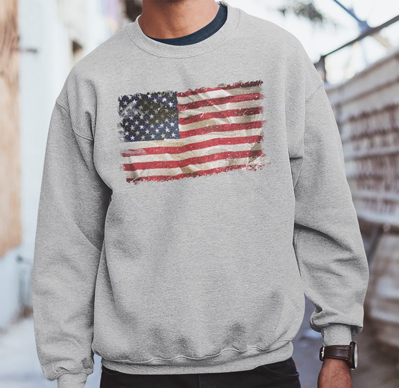 May include: A gray sweatshirt with a vintage-style American flag printed on the front.