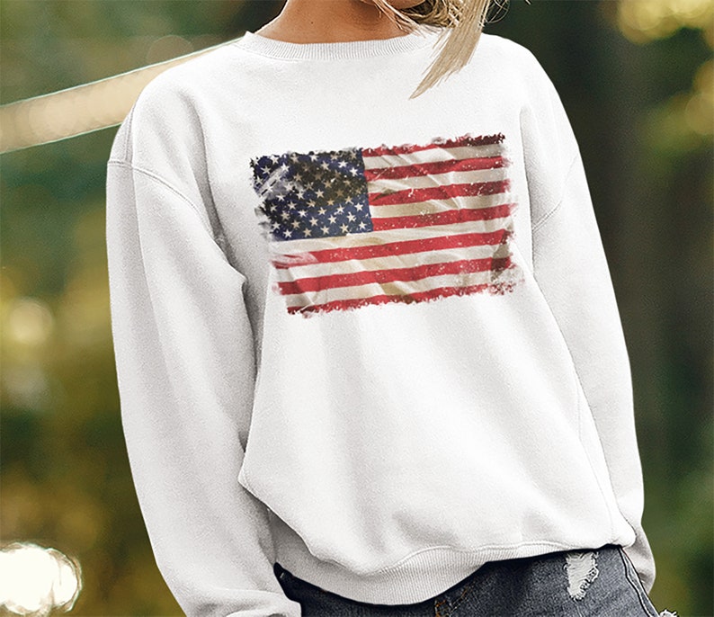 May include: White sweatshirt with a distressed American flag print.