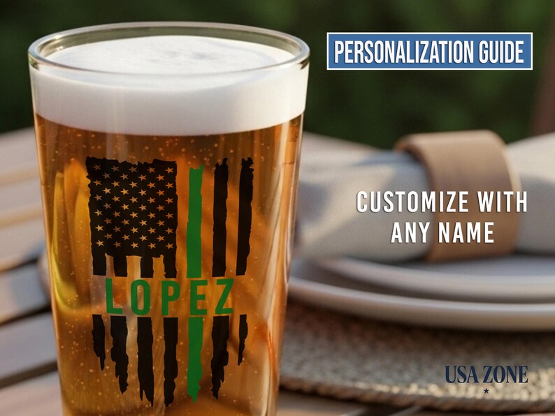 May include: A clear glass pint beer mug filled with amber liquid and white foam. The glass features a black distressed American flag graphic with a vertical green stripe and the name LOPEZ in green text. Text reads PERSONALIZATION GUIDE.