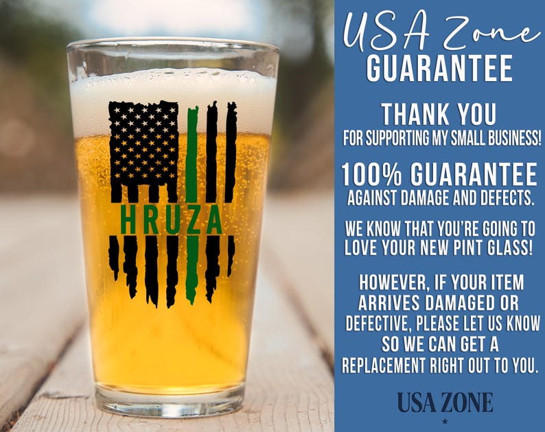 May include: A clear pint glass filled with golden beer, featuring a black and green graphic of a distressed American flag with the name HRUZA printed in green. The text USA ZONE GUARANTEE and additional business information appear to the right.