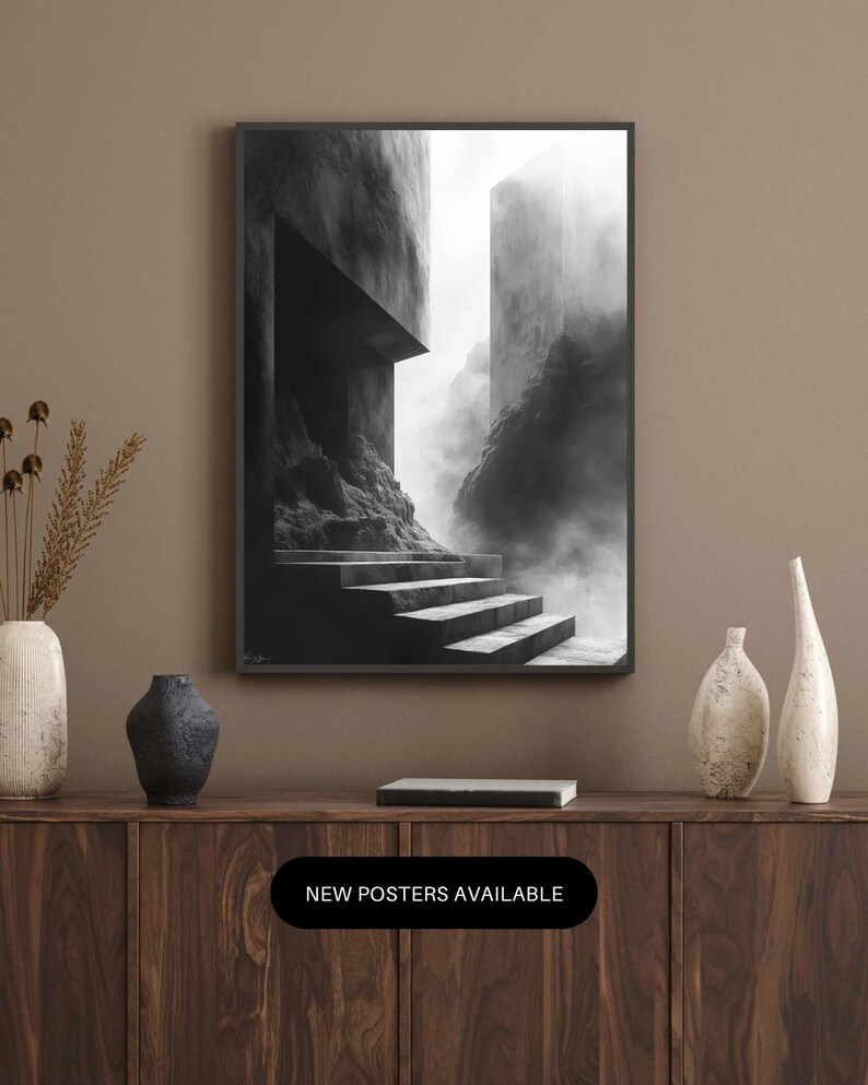 Puede incluir: Impresi&oacute;n art&iacute;stica en blanco y negro de una escalera que conduce a un paisaje arquitect&oacute;nico brumoso. La impresi&oacute;n enmarcada se muestra sobre un mueble de madera. El texto "NEW POSTERS AVAILABLE" se muestra en un &oacute;valo negro.