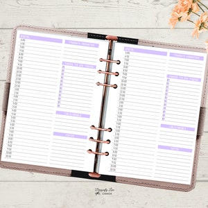 May include: Open planner with a pale pink cover and rose gold rings. The pages are white with a lilac header and lines for scheduling. Sections include "Today's Priorities", "Things to Do Today", "Calls/Emails", and "Notes". The planner is open to a double-page spread.