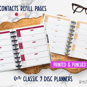 May include: Contact refill pages for Classic 9 disc planners. The pages are white with burgundy and peach accents. The text "CONTACTS REFILL PAGES" and "PRINTED & PUNCHED" are visible. The pages are designed for organizing contact information.