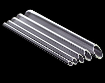 May include: A collection of clear, transparent glass tubes of varying diameters, arranged diagonally against a black background. The tubes are cylindrical with rounded ends, showcasing their hollow interiors. The sizes range from thin to thick, highlighting the product's versatility.