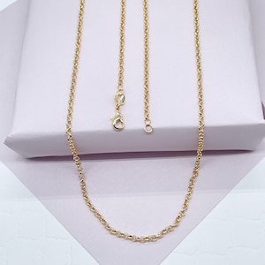 May include: A gold chain necklace with a lobster clasp closure. The chain is made of small, round links.