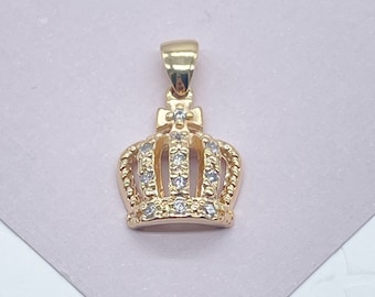 May include: A gold crown pendant with clear cubic zirconia stones.