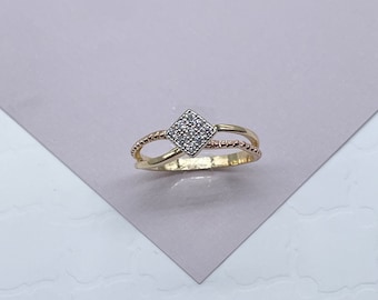 May include: A gold ring with a square-shaped centre stone set with small diamonds. The ring has a twisted band with a two-tone design.