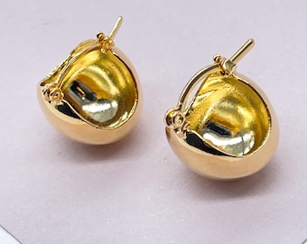 May include: A pair of gold hoop earrings with a smooth, rounded design. The earrings are made of a shiny metal and have a simple, classic style.