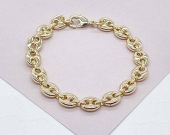 May include: A gold-toned chain bracelet with a mariner link design. The bracelet is made of metal and has a polished finish.