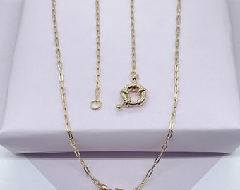 May include: A gold chain necklace with a toggle clasp. The chain is made of small, linked ovals.
