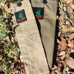 May include: Two canvas pouches with black buttons and a green and red logo that says "Browns Bushcraft".