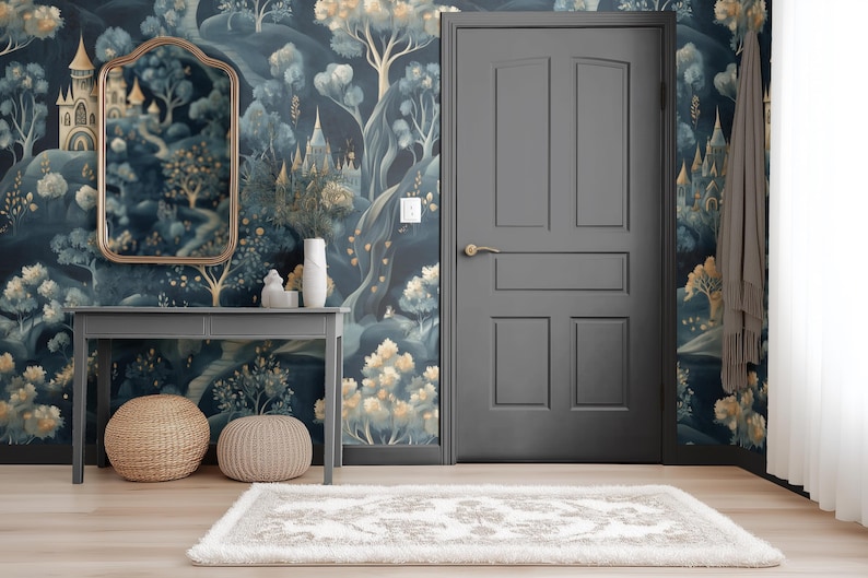 May include: A room with a whimsical mural featuring castles and trees in shades of blue, gold, and green. A gray door, table, and mirror frame complement the wallpaper. Two woven ottomans and a rug complete the decor.