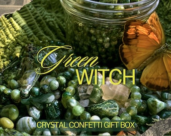 May include: A glass jar filled with various green polished stones, beads, and crystals, accompanied by an orange butterfly. The text Green WITCH and CRYSTAL CONFETTI GIFT BOX is overlaid in yellow and white on the collection of green items.