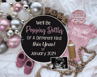 May include: A pink baby onesie with the text "BABY GIRL MCKINNEY" on it. A black letter board with the text "We'll Be Popping Bottles Of A Different Kind This Year! January 2024". A wooden block with the number 2024 on it. A pink and silver balloon garland. A wooden bead necklace. A small pink baby shoe. A clear glass bottle with a wooden top. A black and white ultrasound image.