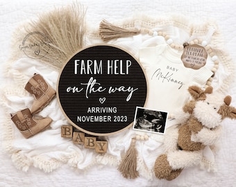 May include: A black letter board with the text "FARM HELP on the way" and "ARRIVING NOVEMBER 2023".  A white onesie with the text "BABY McKinney" is next to the letter board.  There are brown cowboy boots, a stuffed cow, and a wooden block spelling "BABY".