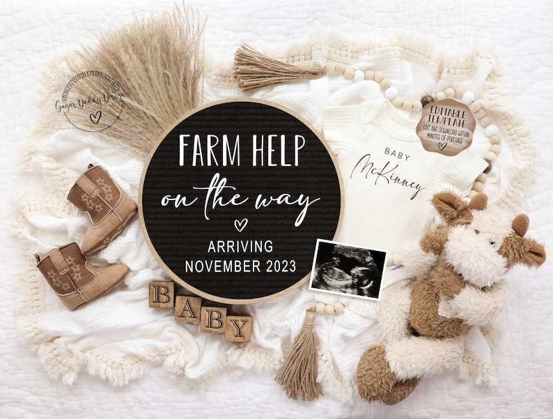 May include: A black letter board with the text "FARM HELP on the way" and "ARRIVING NOVEMBER 2023".  A white onesie with the text "BABY McKinney" is next to the letter board.  There are brown cowboy boots, a stuffed cow, and a wooden block spelling "BABY".