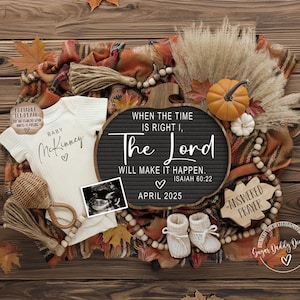 May include: A fall-themed baby announcement with a white onesie that says "Baby McKinney" and a black chalkboard sign that says "When the time is right, the Lord will make it happen. Isaiah 60:22. April 2025".