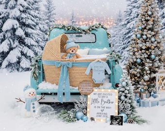 May include: A winter-themed baby announcement scene. A light blue vintage truck bed holds a woven bassinet with a teddy bear, a baby onesie, and a sign that says "We are excited to say a Little Brother is on the way!" A snowman and Christmas tree are also present.
