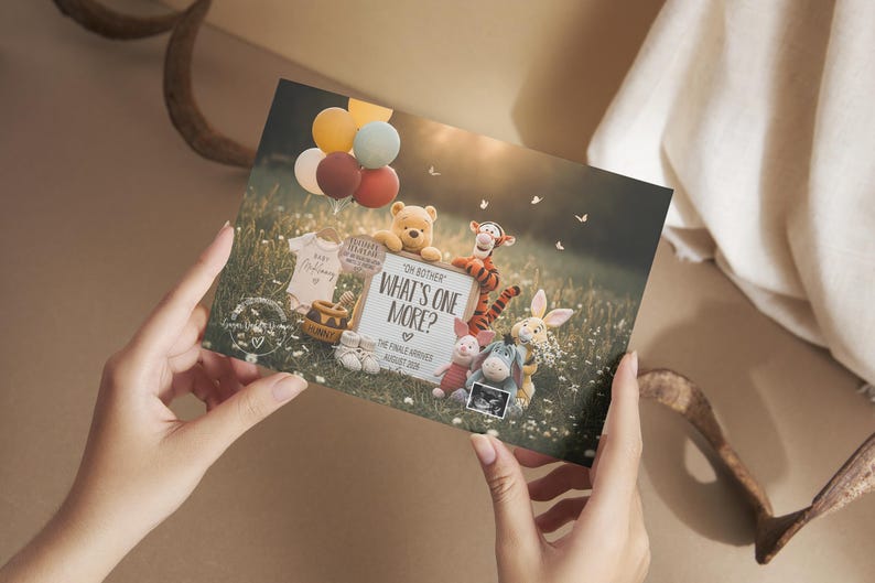 May include: A card with a meadow scene featuring Winnie the Pooh characters, balloons, and the text "What's One More?" announcing a new baby. The card includes a sonogram and baby clothes.