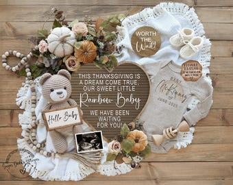 May include: A pregnancy announcement with a brown teddy bear, a white blanket, a sign that says "This Thanksgiving is a dream come true, our sweet little Rainbow Baby. We have been waiting for you!" and a baby onesie that says "Baby McKennely June 2025".