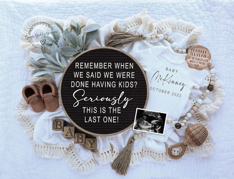 May include: A black letter board with the text "Remember when we said we were done having kids? Seriously this is the last one!"  A white onesie with the text "Baby McKinney October 2023" and a small ultrasound image are also in the image.