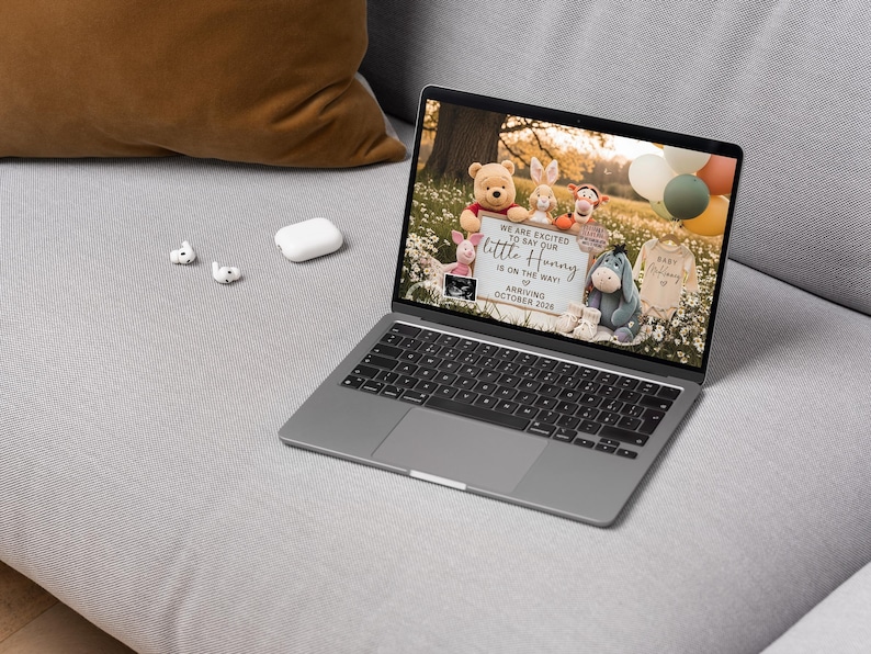 May include: A laptop displays a pregnancy announcement with Winnie the Pooh characters. The announcement reads "We are excited to say our little Hunny is on the way, arriving October 2024." The screen also shows a sonogram and baby clothes.