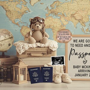 May include: A teddy bear wearing aviator goggles sits atop vintage suitcases, with a globe and a sign that reads "We are going to need another Passport." Two passports and baby booties are also visible, with a world map backdrop.