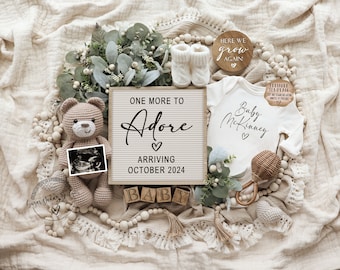 May include: A pregnancy announcement with a neutral color scheme. The announcement includes a letter board with the text "One More to Adore, Arriving October 2024", a baby onesie, a teddy bear, baby booties, and a sonogram.