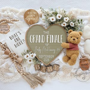 May include: A baby announcement featuring a heart-shaped sign that reads "The Grand Finale" with the baby's name and due date. A Winnie the Pooh plush, a onesie with "What's One More?" and wooden blocks spelling "BABY" are also included.