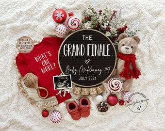 May include: A Christmas-themed pregnancy announcement with a black chalkboard sign that reads "The Grand Finale Baby McKinney #4 July 2024". There are red and white ornaments, a red onesie with the text "What's One More?" and a pair of red baby booties.