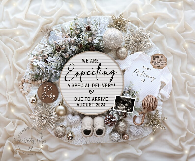 May include: A white baby onesie with the text "Baby McKinney" and two hearts. The onesie is surrounded by a white knitted blanket, a wooden sign that says "We are Expecting a Special Delivery! Due to Arrive August 2024", a wooden ornament that says "Oh Baby", a small wooden rattle, a baby bootie, a gold star, and a gold ornament. The background is a white and gold fabric.