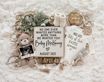 May include: A white onesie with the text "Made with lots of love & a little science" and a heart. A brown wooden sign with the text "The little embryo that could!" A brown wooden letter board with the text "No one ever wanted anything more than we wanted you! Baby McKinney ♡ August 2025". A brown teddy bear holding a sonogram image.