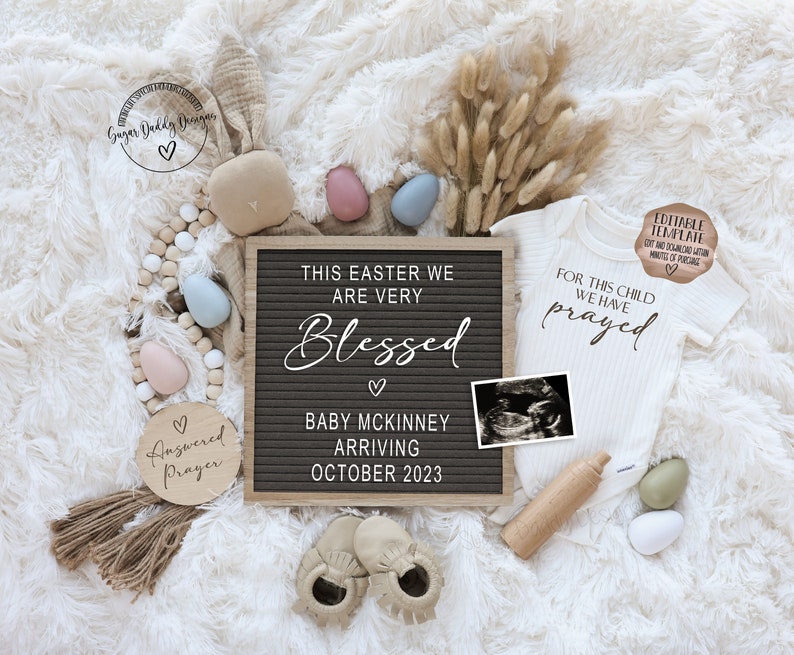 May include: A pregnancy announcement with a letter board that reads "This Easter we are very blessed. Baby McKinney arriving October 2023". There is a small ultrasound image, a white onesie with the text "For this child we have prayed", and a wooden sign that says "Answered Prayer".