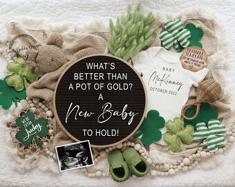 May include: A black letter board with the text "What's better than a pot of gold? A new baby to hold!" surrounded by green shamrocks, a white onesie with the text "Baby McKinney October 2023", a green and white striped shamrock, a brown rattle, and a small ultrasound image.